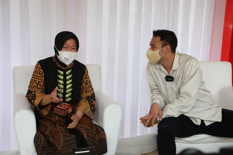 Indonesian Minister of Social Affairs Tri Rismaharini talks with Indonesian celebrity Raffi Ahmad